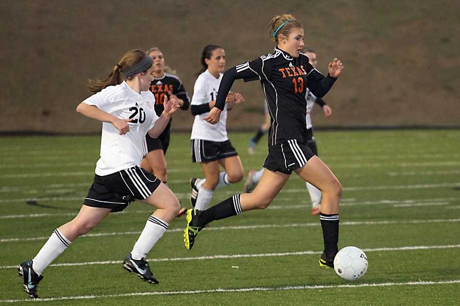 Sophomore Hannah Brantley (13) dribbles down the field against the Pleasant Grove Lady Hawks.