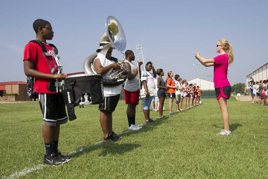 Senior drum major Madison Norton works with band members during summer practice.