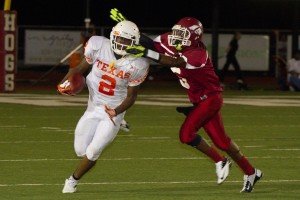 Attempting to escape a tackle, senior Treveon Walker carries the ball down field.