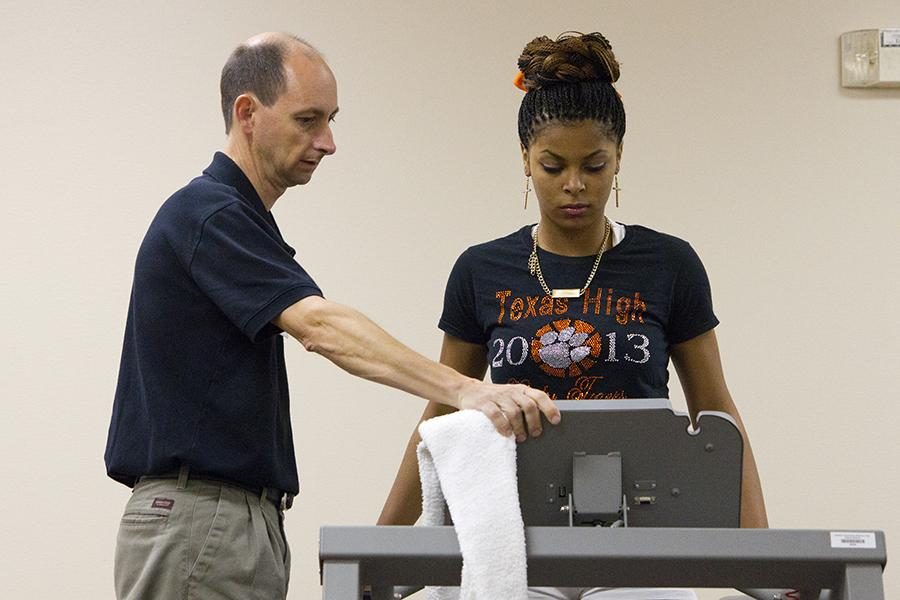 Working with her physical therapist, junior Chanell Hayes recovers from a torn ACL.