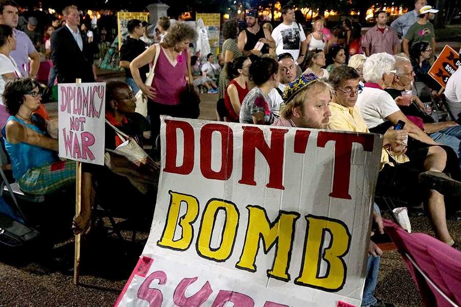Protesters listen to President Barack Obamas speech on Syria in Washington, D.C., Tuesday, Sept. 10.