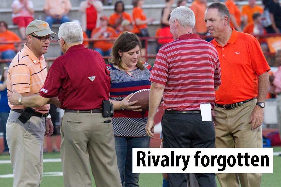 Former Texas High teacher Stephanie Sprague receives a commemorative game ball in honor of her late husband, Officer William Sprague, during the annual Texas High versus Arkansas High football game Friday.