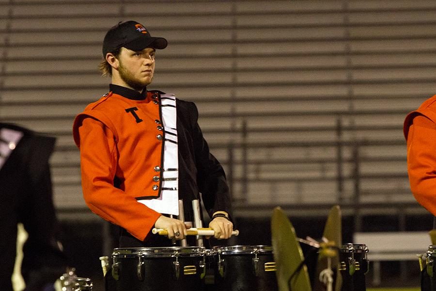 On the field, senior Bradley Baird performs at the Fire Ant Classic. The band won the competition for the second year in a row.