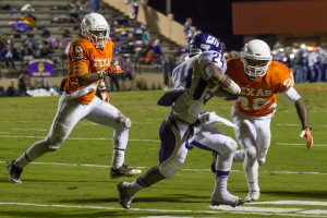 During a play, seniors Anthony Rhone (8) and Marquan Daniels (22) hunt down the opposing running back.