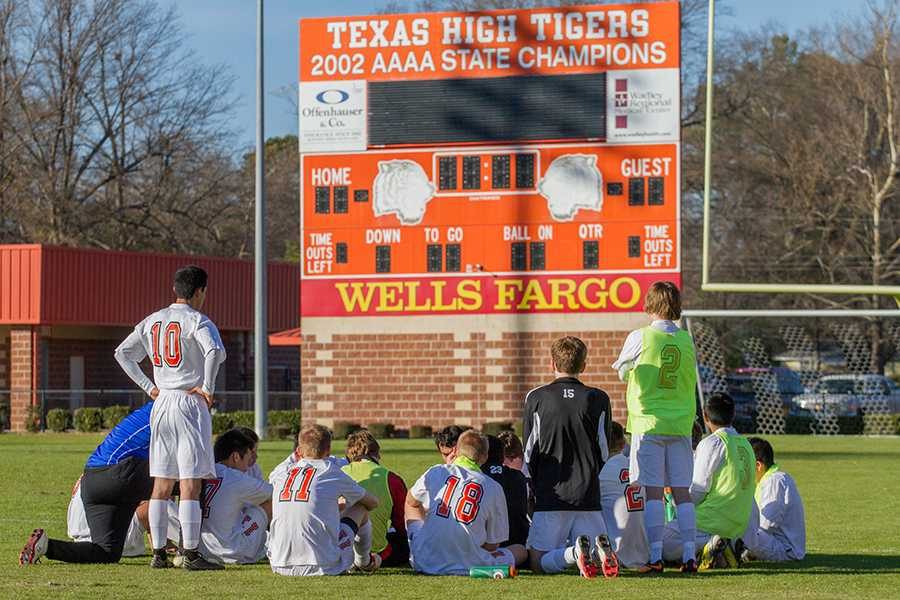 Boys varsity soccer team reflects during their game against Henderson.