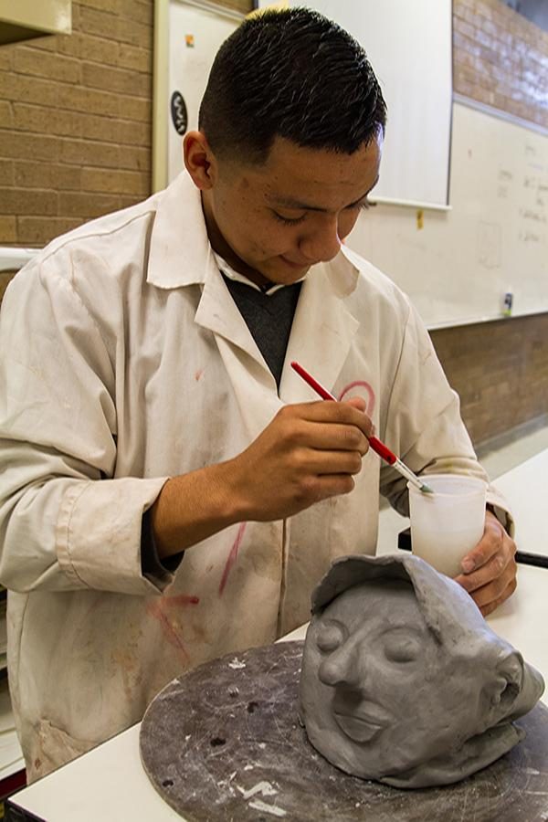 Student works on sculpture during art class