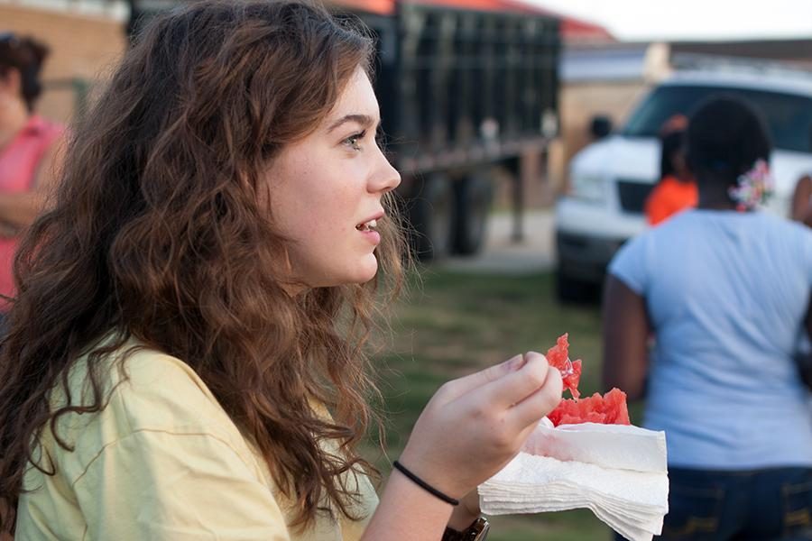 Sophomore Grace Hickey dives into a slice of watermelon during the annual Watermelon Supper Aug. 23