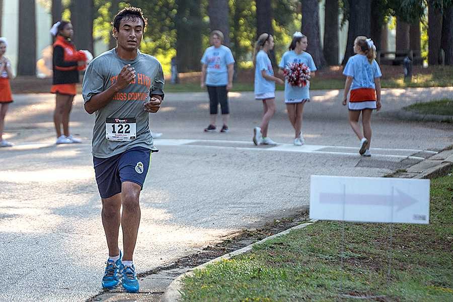 Senior Luis Moreno follows the signs through Spring Lake Park during the Dash for Cash 5k.