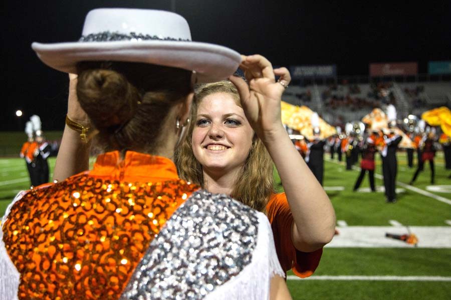 Olivia Johnson ensures that the small details of a Highsteppers uniform is in place before the teams halftime performance.