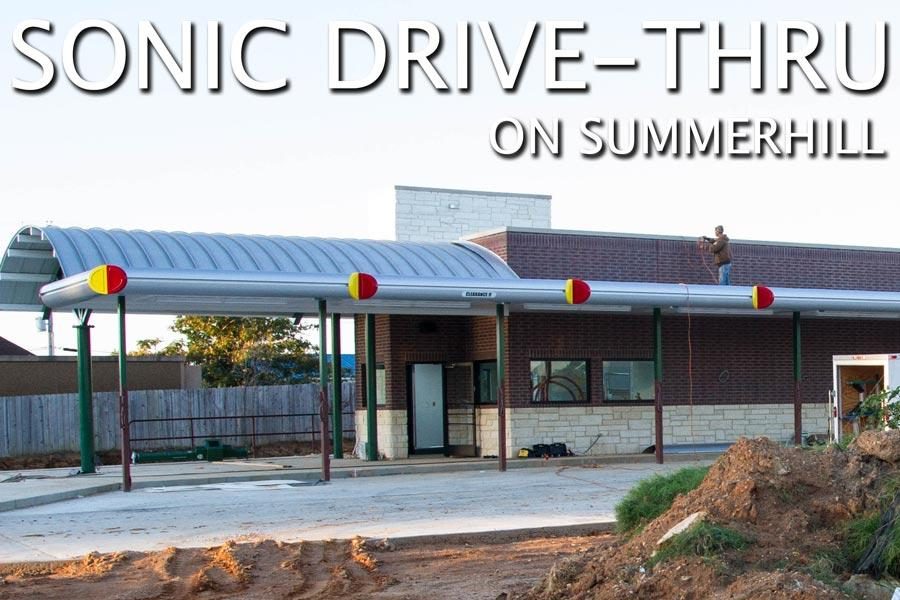 A worker puts the finishing touches on the awning of the new Sonic Drive-Thru on Summerhill Rd.