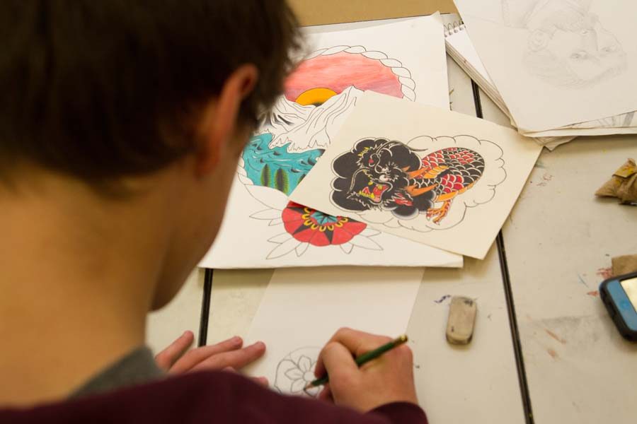 Artist Connor Anderson focuses on a few sketches in class