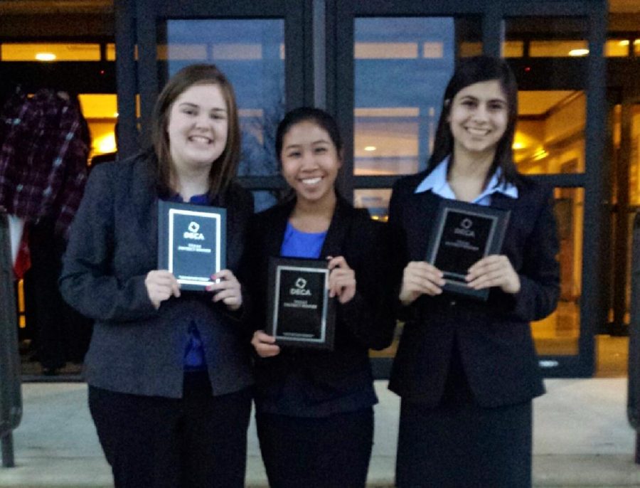 Juniors Colleen Russell, Alana Tran and Naveen Malik smile after being awarded in DECA competition. Photo by club sponsor 
