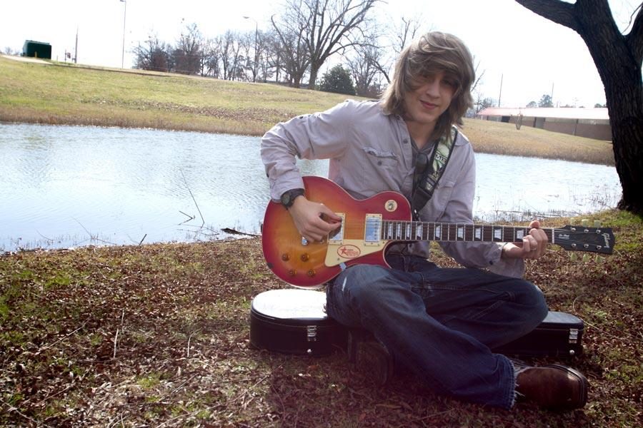 Sophomore Darren Mercer props his guitar and strums as he begins to practice a few melodies.