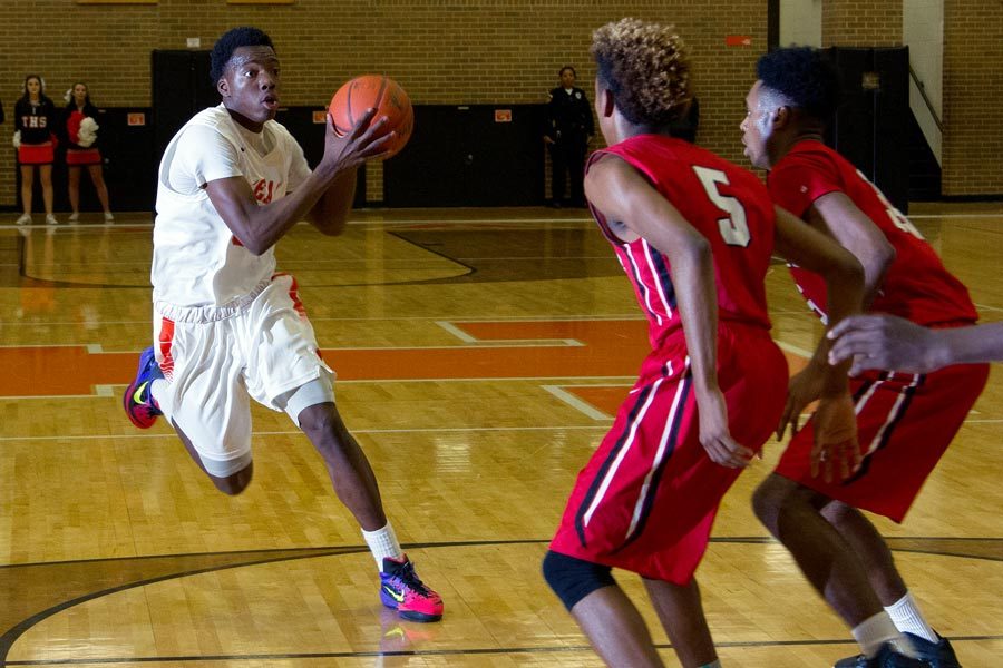 JaNiro Lane drives toward the basket during the boys varsity basketball game against Marshall. The Mavericks defeated the Tigers 86 - 68.