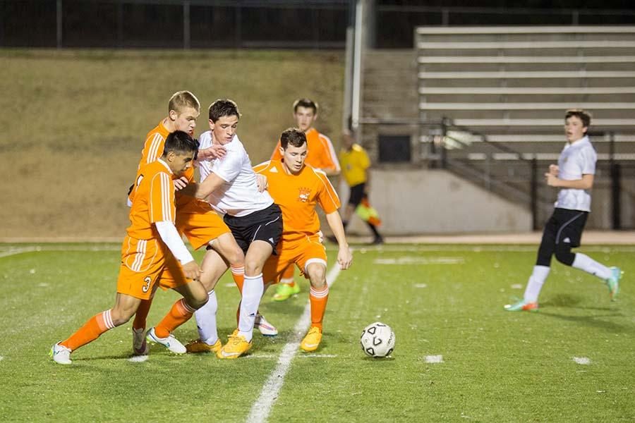 A host of Tigers battle a lone Pleasant Grove defender during the boys varsity game on January 20, 2015.