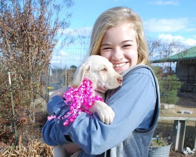 Senior Katherine Doan poses with the found pup. Photo taken by Jennifer Doan