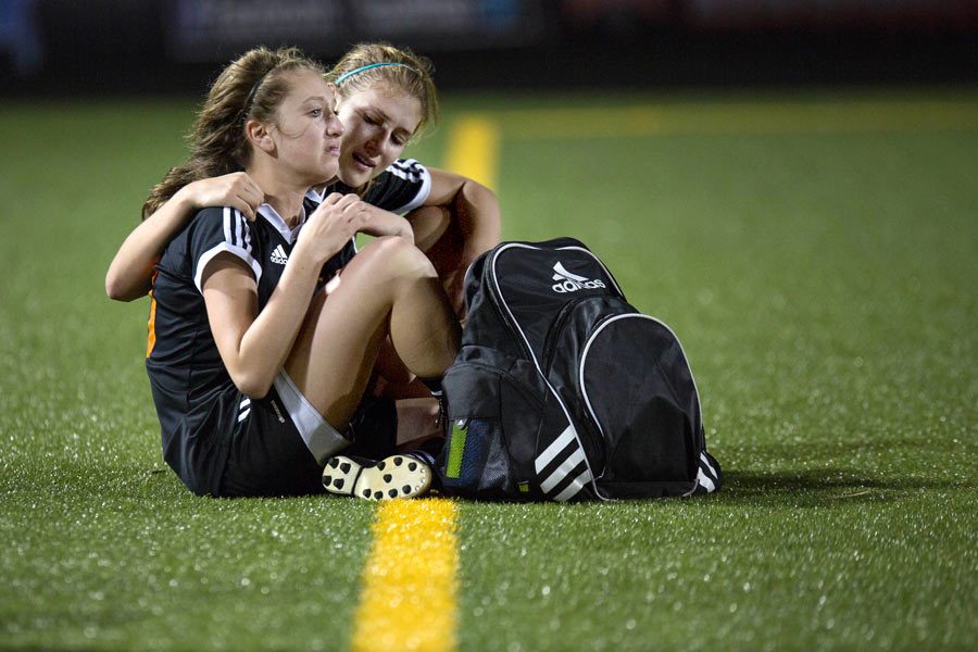 Senior Hannah Brantley tries to comfort freshman Brylee Bender after a 1-5 loss against the Lake Ridge Eagles in the AAAA Girls Soccer Playoff game in Tyler, TX. The loss ended the Lady Tigers season with a record of 20 wins and only four losses.