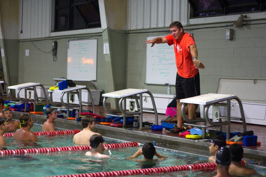 Coach Carl Auel demonstrates freestyle for the team. Auel announced his resignation on Aug. 21. File Photo