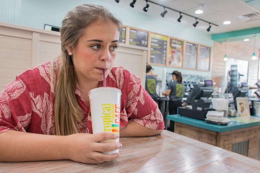 Senior Jessica Emerson enjoys a smoothie at Tropical Smoothie Cafe. The cafe held its grand opening on Aug. 14.