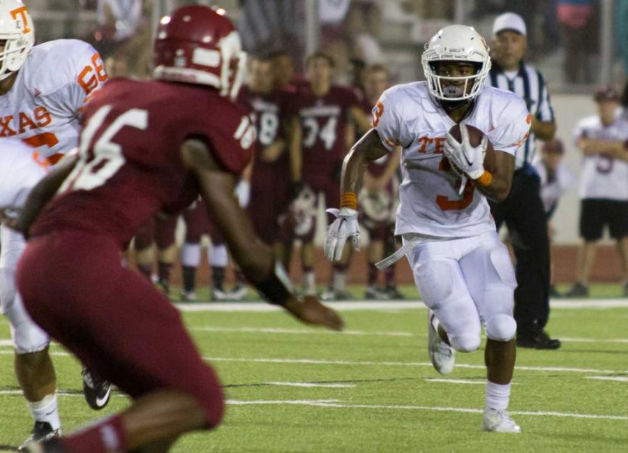 Texas Highs JKardi Witcher looks for open field in which to run during the 2015 Texas vs. Arkansas game held at Razorback stadium. Witcher scored 3 touchdowns in the 28 -14 victory.