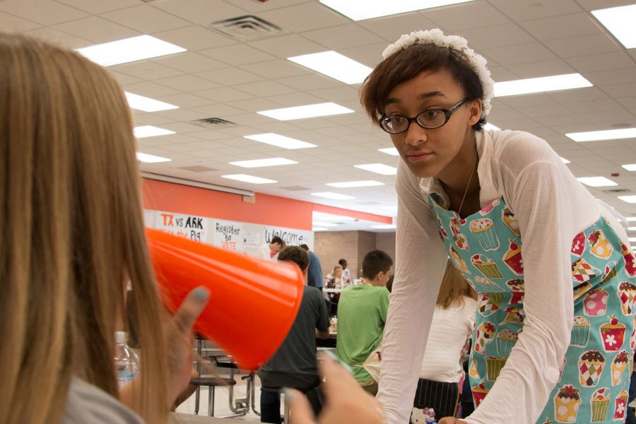 senior Brittini Simmons listens to junior Megan Harris at the club drive. 