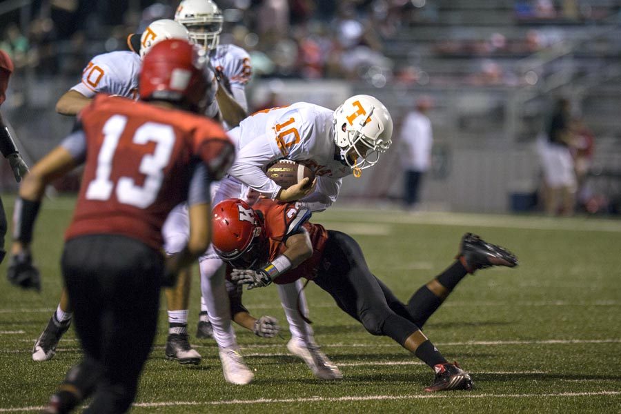 Texas High quarterback Cade Pearson absorbs a hit by a Kilgore linebacker Sept. 18, 2015. The Tigers lost to the Bulldogs 21-17 for their first loss of the 2015 season.