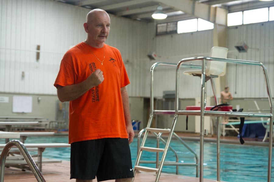 Coach Eric Vogan explains a drill to swimmers during after school practice. 