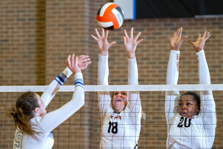 Freshman Kaitlyn Cross and senior Kristen McDuffie attempt to block a spike in the game against Sulphur Springs. The Lady Cats defeated the Lady Tigers 3-0.