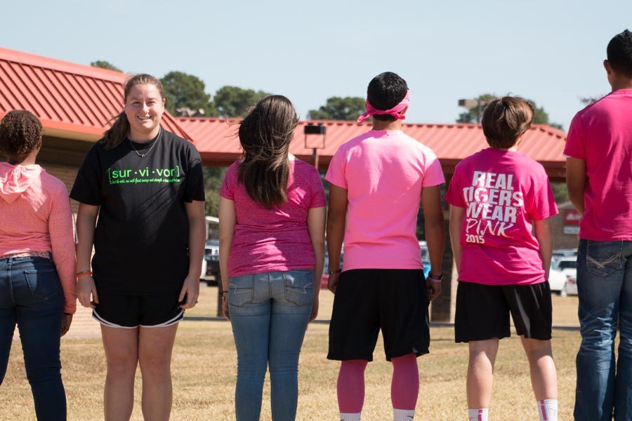 Senior Kaylyn Coleman proudly displays her green shirt. Coleman wears green to support her father, who is a lymphoma survivor.