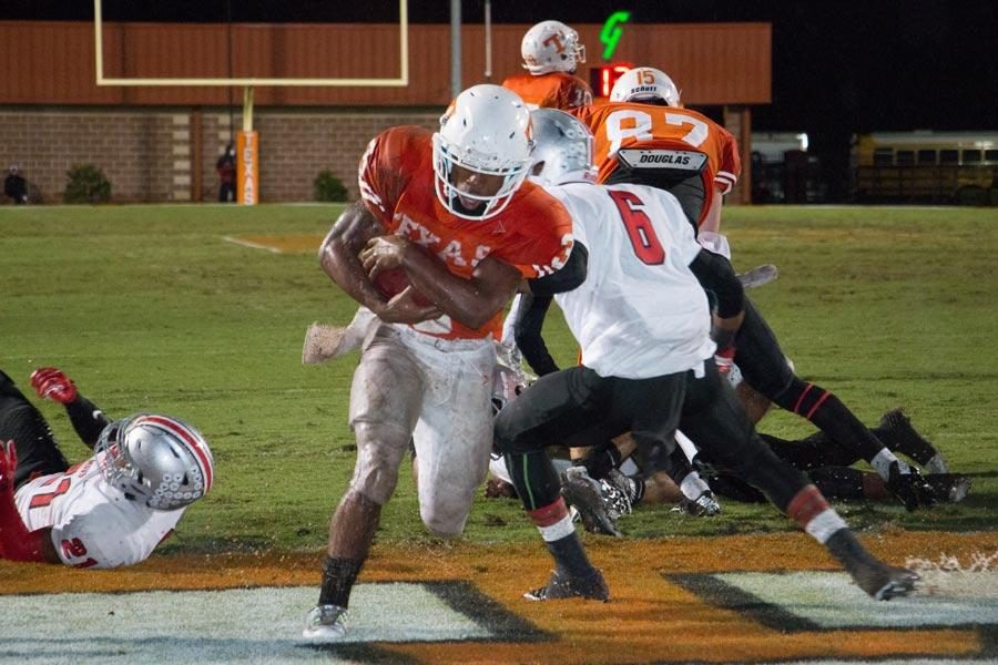 Running back  JKardi Witcher scores a touchdown against Marshall the 27-7 victory over the Mavericks.  Witchers scored four touchdowns in the game, helping to clinch a share of the district championship with Marshall.