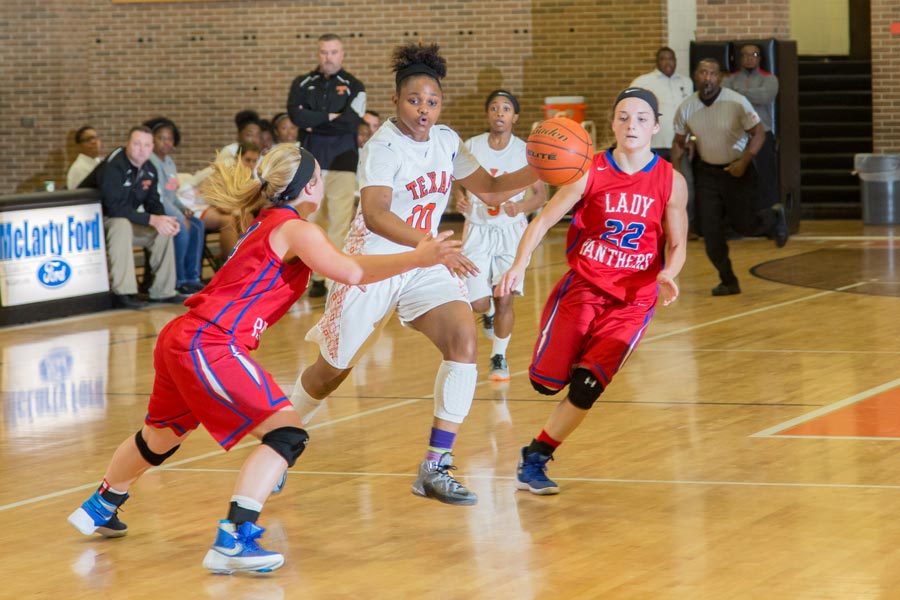 Freshman Antonia Porter attempts to drive past the Alba-Golden defenders. The Lady Tigers were defeated 75-65 by the Alba-Golden Lady Panthers.