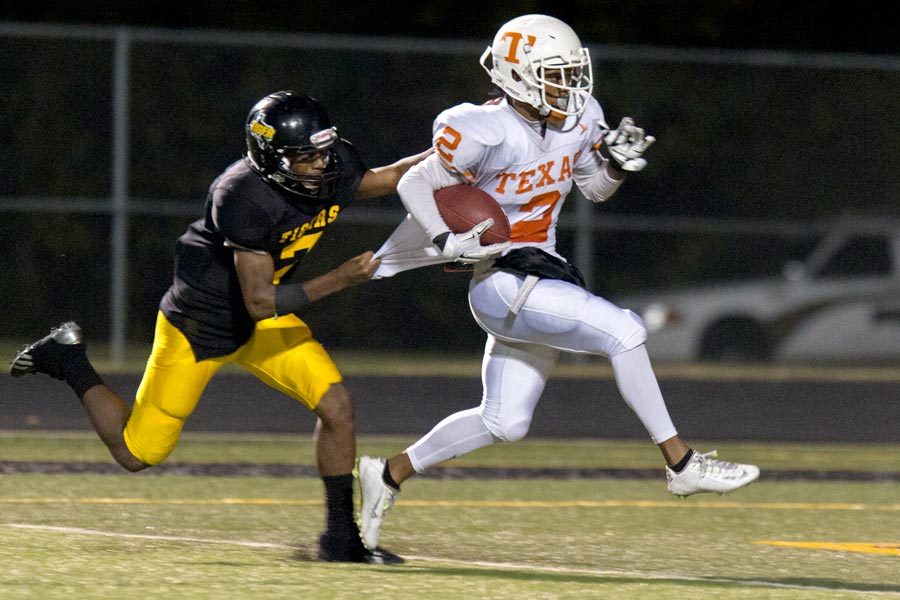 Texas Highs Quan Hampton pulls away from a Mt. Pleasant defender in the last district game of the season for the Tigers. Hampton scored a 43-yard touchdown in the fourth quarter against Mt. Pleasant.