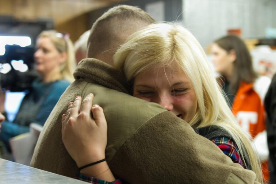 Junior Piper Spaulding hugs her brother Sawyer Spaulding. Sawyer surprised his two younger sister after serving in Afgahanistan and Italy for the last 22 months.