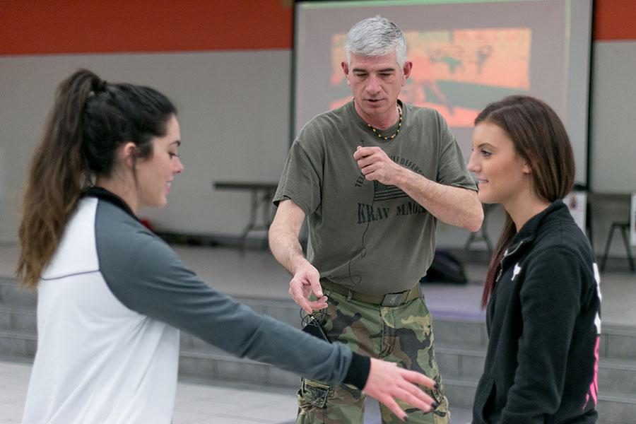 Seniors Julia Nations and Savanna Shively practice skills they learned in the Rosebuds self defense class on Jan. 14. 