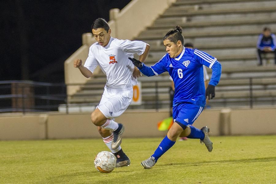 Senior Roger Moreno dribbles past a defender.