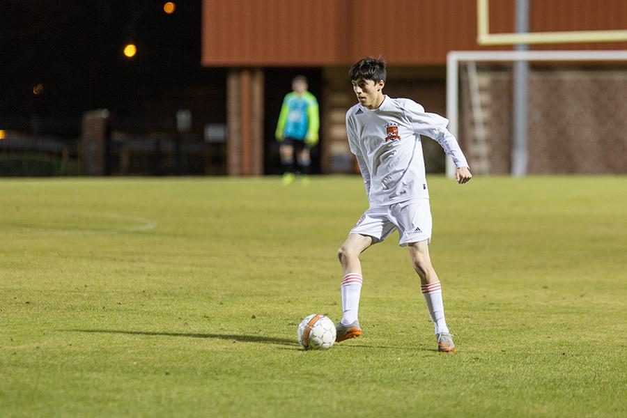 Senior Ethan Montez dribbles the ball up the field. 