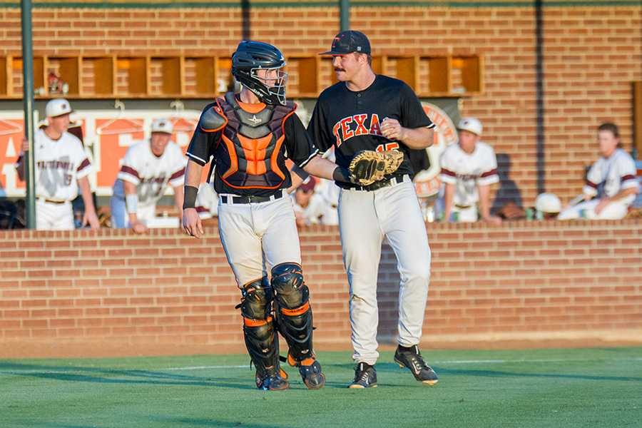 Senior catcher Trevor Danley encourages senior pitcher Kip Williams in the first playoff game against Whitehouse on Friday.