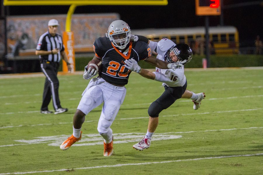 Senior running back Markese Martin stiff arms Liberty-Eylaus Triston Brooks. The Tigers defeated the Leopards 48-39. 