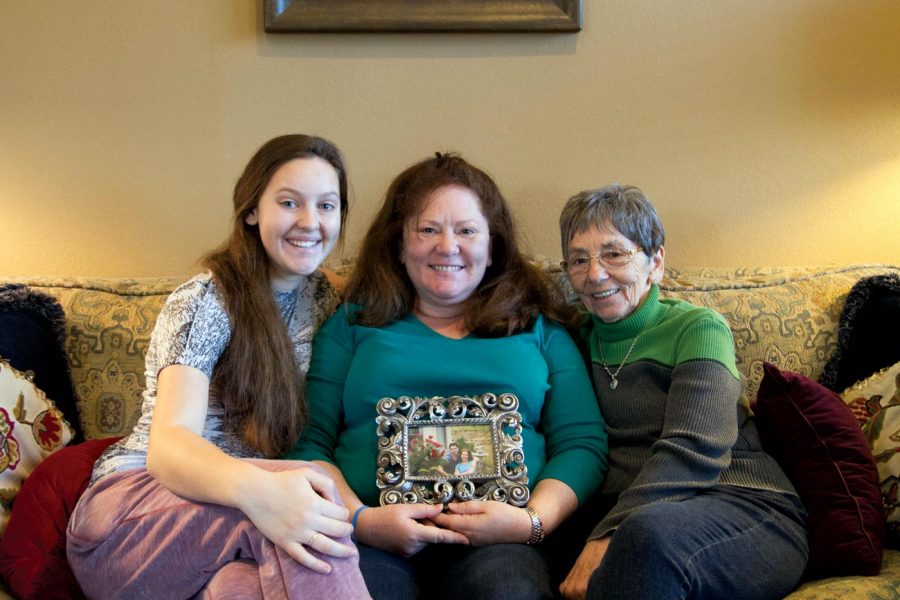 Leah Crenshaw, Mary Kaye Crenshaw (mother) and Claire Taylor (grandmother) hold a picture of Leahs uncle. File photo.