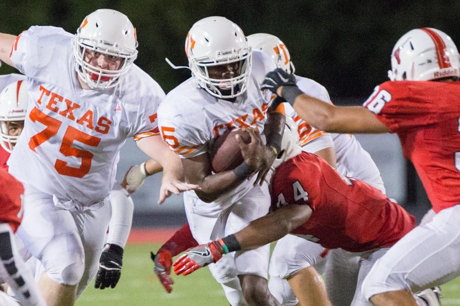 Texas Highs Devuntay Walker pushes his way through Marshalls defenders Friday night at Maverick Stadium. The Tigers defeated the Mavericks with a second half surge, making Texas High undefeated going into a bye week.