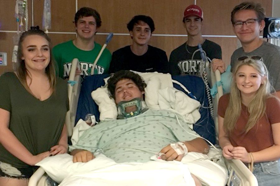 Mayten Lumpkin lies in his hospital bed surrounded by his friends. Pictured left to right are Rachel Sorenson, Bryan Lovell, Connor Anderson, Grant Owens, Dalton Dickson and Jera Davis. Submitted Photo.