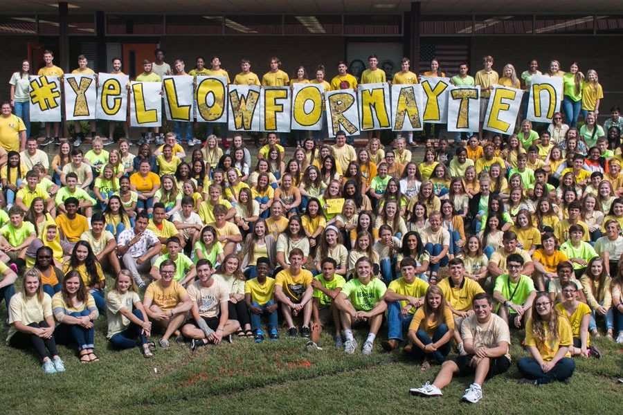 Students gather in the pit for a group photo in support of senior Mayten Lumpkin, who was involved in a diving accident Saturday. 