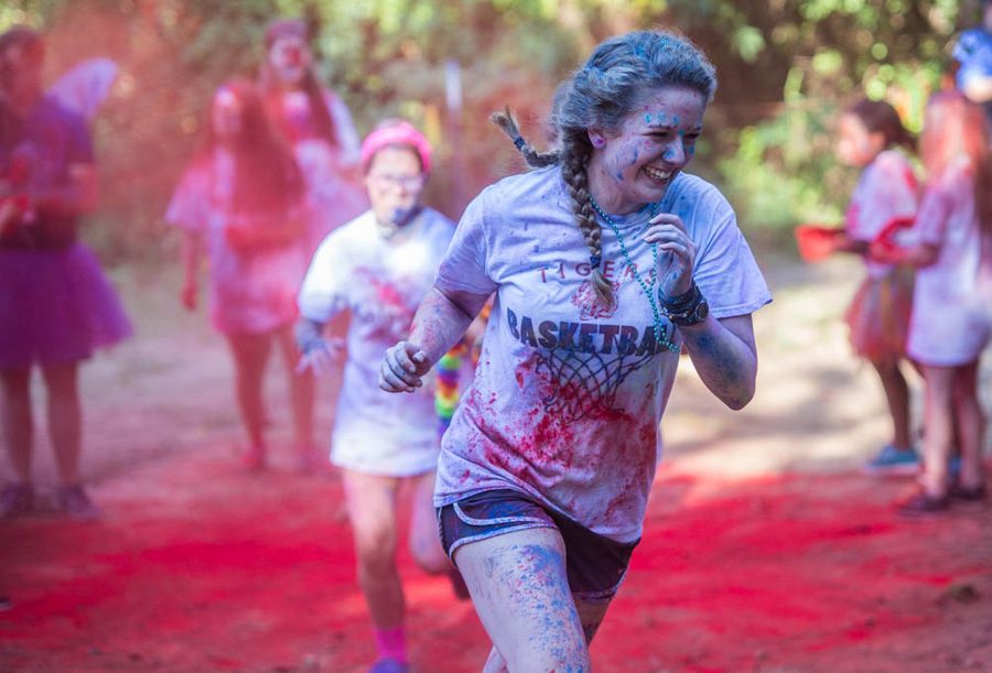 Junior Blair Bledsoe runs the trail in the CASA Color Run. The Color Run was held at Trinity Church on September 24. 