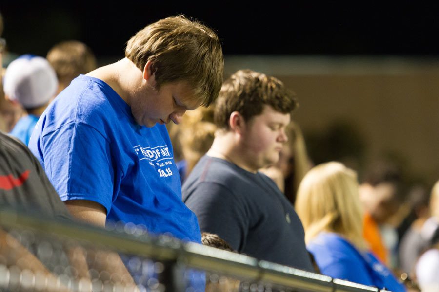 Junior Colin Runnels bows his head in prayer at last years Fields of Faith.