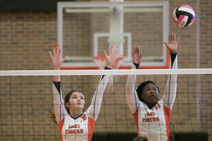 Freshman Carleigh Sharp and junior Alexis Smith jump for the ball in the Hallsville game. The Lady Tigers played the Lady Cats on Oct. 4.