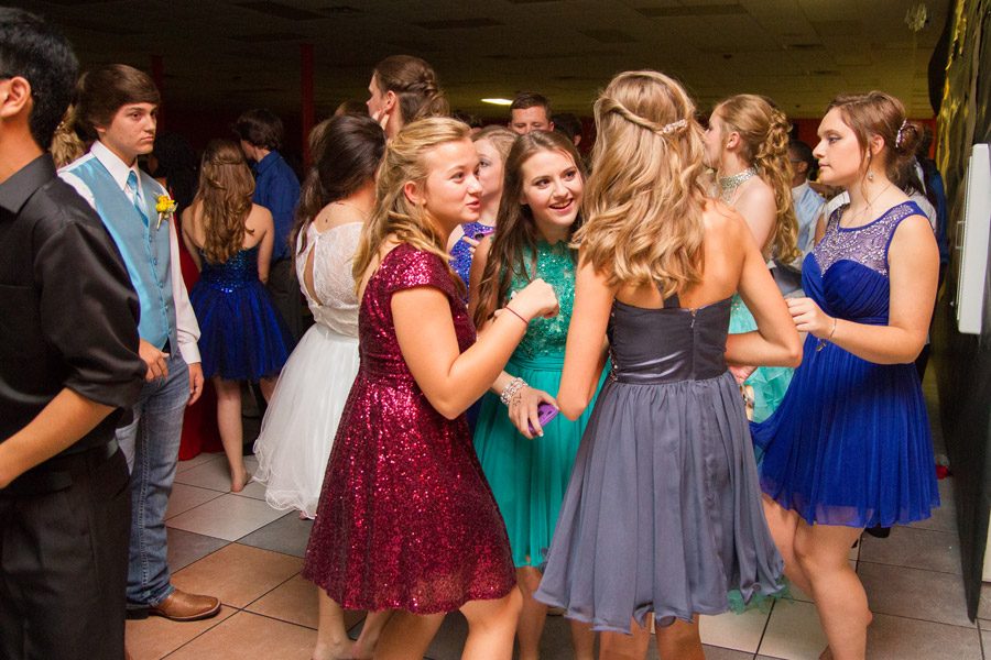 A group of students chat animatedly at last years Homecoming dance.