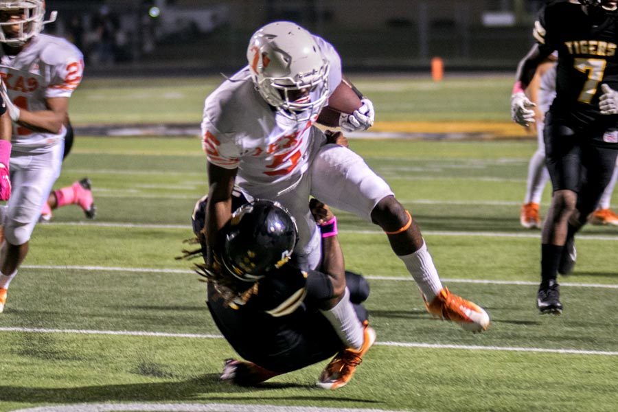 Senior Devuntay Walker fights through a Mt. Pleasant High School defender Friday night in Mt. Pleasant.  The Texas High Tigers defeated the Mt. Pleasant 27-7 and remain undefeated heading in to week 8 of the 2016 football season.