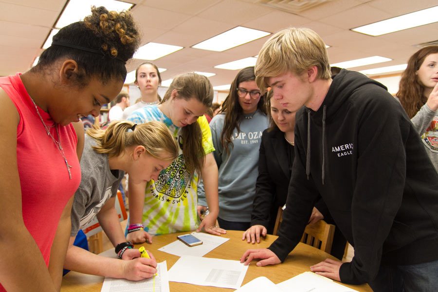 Club members sign in at a meeting.