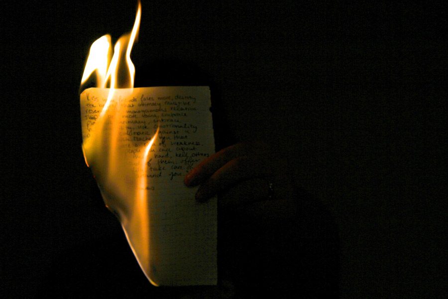 Flames consume a page of her journal. She has kept a journal for all four years of high school to help her cope with her fathers alcoholism and her brothers drug addiction.