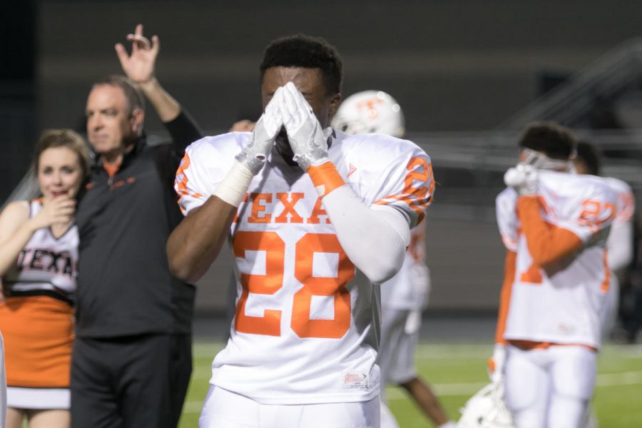 Senior DAndre Purifoy and other players wipe tears from his eyes while coach Barry Norton leads the team during the playing of the school song after the Tigers were defeated in the playoff game against West Mesquite. The Texas High Tigers end their season with a record of 10-1.